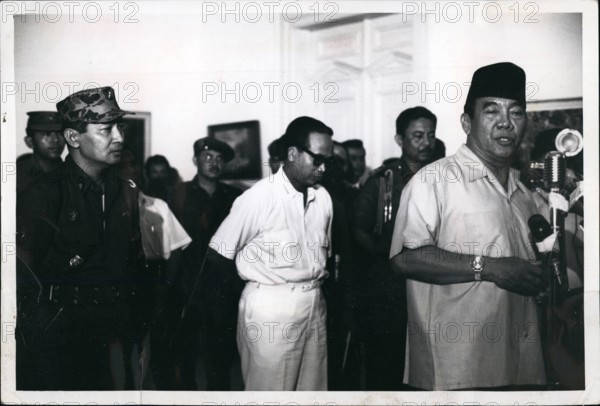 Mar. 27, 2012 - President Sukarno (Right) announces appointment Oct 14, 1965 of Maj Gen Suharto (left) as Army Chief of Chief. Suhar to replaces Lt. Gen Achmad Yani, who was killed by communist in aborted coup of Oct 1. 195. In center is Dr. Subandrio, 1st deputy minister. Ceremony is at Istana Palace, Djakarta, Indonesia. Sukarno Made a deal with the military (Who routed the communist) to appoint Suharto providing that Subandrio stayed in Cabinet (military wanted Subandrio out). Behind Subarno, his chief Body coard brig gen. Sabur. Credit : Carol Goldstein