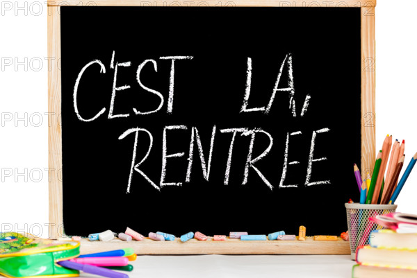 Back to school in french on black chalkboard and color chalk