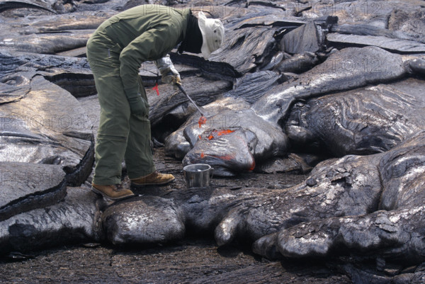 A volcanologist collects lava samples at Hawaii Volcanoes National Park, part of the U.S. Geological Survey’s ongoing research into volcanic activity. The park is home to Kilauea, one of the world’s most active volcanoes, providing valuable data for understanding natural hazards and volcanic science.