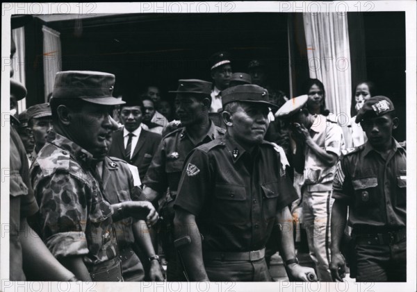 1965 - General Abdul Haris Nasuton, Centre, griefstricken, as he leaves his house in Djakarta for funeral of his 5-year-old daughter who was fatally wounded in the aborted communist coup of Oct 1, 1965. Nasution is Indonesian defense miniter. At left, in jungle uniform is Maj G n Suharto, who led military in crusihing the communist. he was later appointed army chief of staff. © Keystone Pictures USA/ZUMAPRESS.com/Alamy Live News
