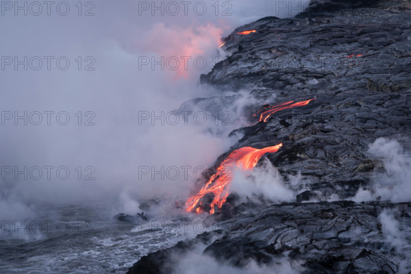 Lava from Pu'u O'o eruption entering the ocean; Hawaii Volcanoes National Park, Island of Hawaii.