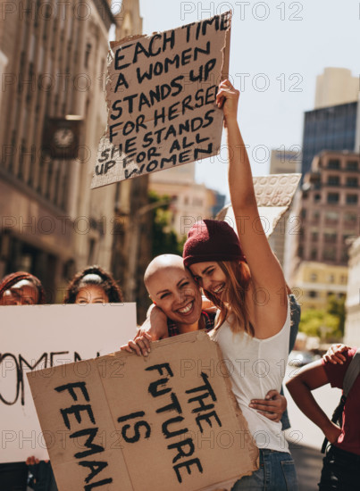 Group of young female activists protesting with signboards on road. Women enjoying during a demonstration on road.