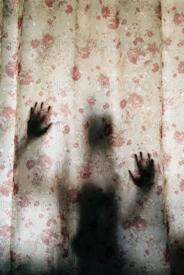 vertical image of mysterious human shadow behind a curtain. fear, Mystery, scary, creepy and paranormal concept