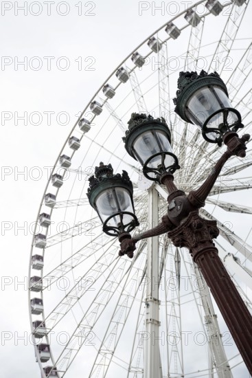 The Big Wheel at Place de la Concorde and a street lamp in the foreground in Paris. France