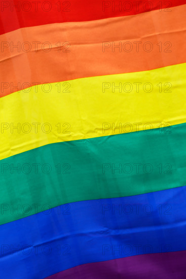 Close-up of a flag with rainbow pattern.
