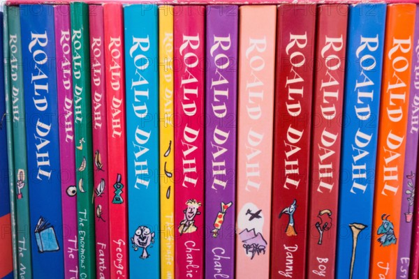 Closeup of colourful Roald Dahl book covers, spines, illustrations and artwork