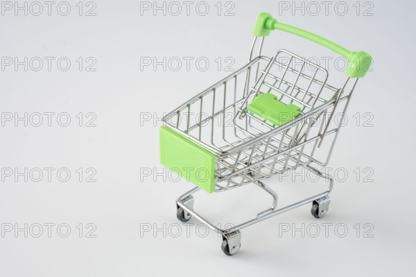 Small shopping cart on gray background. shopping concept. space for text