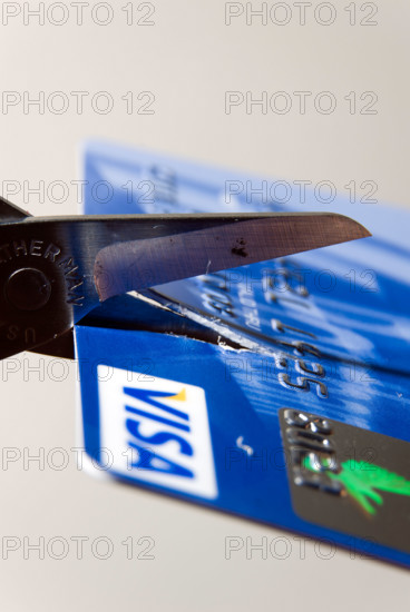Scissors cutting up bank credit card