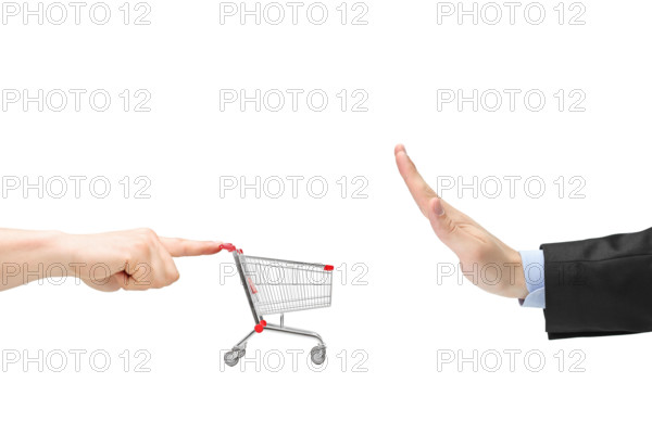 Finger pushing an empty shopping cart and male hand gesturing stop isolated on white background