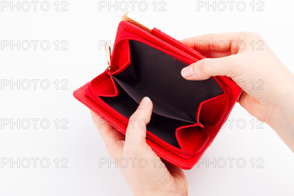 Female hands with an empty wallet on white background