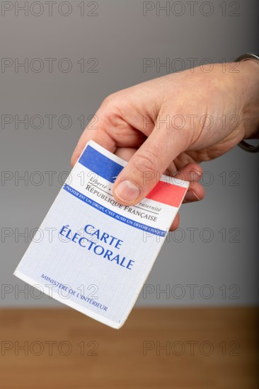 Paris,  France - November 22, 2019 : woman holding a voter card in her hand