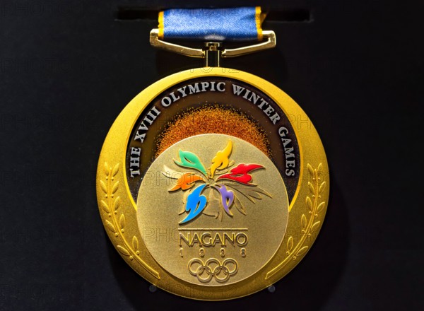 tokyo, japan - march 2 2021: Close up on the official gold medal used during the 1998 Winter Olympics of Nagano exhibited in the Japan Olympic Museum.