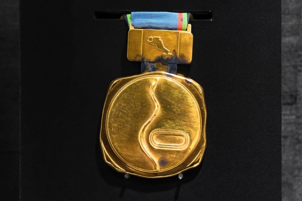 tokyo, japan - march 2 2021: Close up on the official gold medal used during the 1972 Winter Olympics of Sapporo exhibited in the Japan Olympic Museum