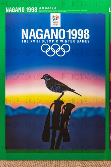 tokyo, japan - august 10 2021: Japanese poster of Nagano 1998 winter olympics games depicting a thrush perched on a ski pole with mountains