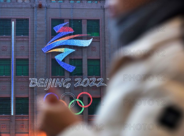 Beijing, China. 10th Feb, 2022. View of the emblem of the 24th Winter Olympic Games and the Olympic rings hanged on the wall of Beijing department store in the background. The 24th Winter Olympic Games have been held in February 2022 in Beijing, China. The city is full of festive atmosphere with the winter Olympic logo and posters of the mascot "Bing Dwen Dwen" plastered in the streets of Beijing. Credit: SOPA Images Limited/Alamy Live News
