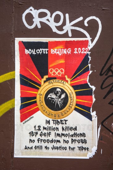 Torn poster calling for boycott of Beijing Olympic Games 2022 in Greenwich Village of New York City, United States of America