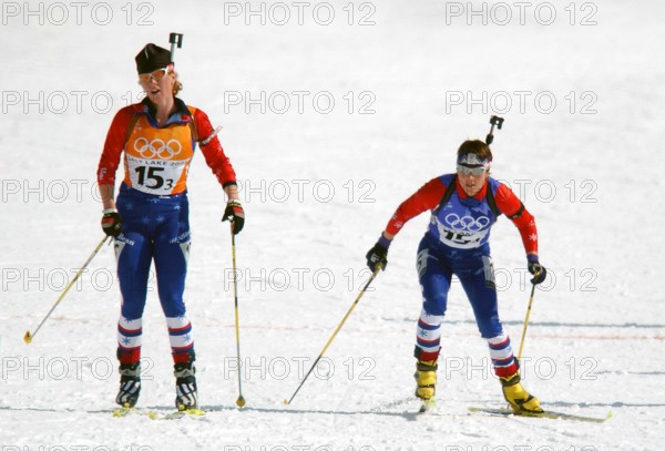 Competing in the Biathlon event, World class athlete Sergeant Kristina Sabasteanski, USA, (right) takes off for her anchor leg of the women's 4 X 7.5km Relay competition in the 2002 OLYMPIC WINTER GAMES after being tagged by teammate Rachel Steer. The Relay competition consists of four team members; each must ski 7.5 km, with two firing bouts, one prone and one standing, each bout with unsupported rifle. Team USA would finish the race in 15th place, 13:21.0 behind the leader. Subject Operation/Series: 2002 OLYMPIC WINTER GAMES Base: Salt Lake City State: Utah (UT) Country: United States Of Ame
