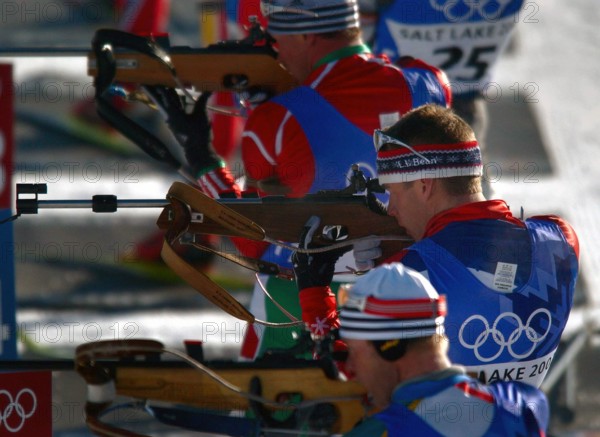 Competing in the Biathlon event, World Class Athlete SPECIALIST (SPC) Jeremy Teela, USA, takes aim at his targets during the third lap of the men's 12.5km Pursuit competition, at Soldier Hollow, in the 2002 WINTER OLYMPIC GAMES. SPC Teela finished the race 21st, 2:43.5 behind the leader. Subject Operation/Series: WINTER OLYMPIC GAMES 2002 Base: Salt Lake City State: Utah (UT) Country: United States Of America (USA)