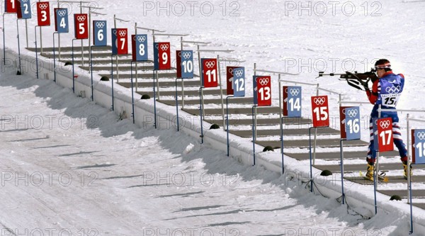 Competing in the Biathlon event, World class athlete Sergeant Kristina Sabasteanski, USA, takes aim with her .22 caliber, bolt-action rifle at one of the five targets in the round. She is the last competitor in the range for the women's 4 X 7.5km Relay competition in the 2002 OLYMPIC WINTER GAMES. The Relay competition consists of four team members; each must ski 7.5 km, with two firing bouts, one prone and one standing, each bout with unsupported rifle. Team USA would finish the race in 15th place, 13:21.0 behind the leader. Subject Operation/Series: 2002 OLYMPIC WINTER GAMES Base: Salt Lake