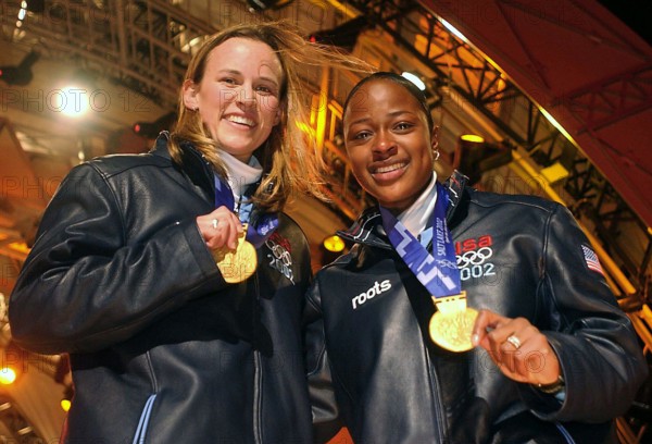The first winners in the 2002 OLYMPIC WINTER GAMES debut for womens two-man bobsledding. World Class Athlete SPECIALIST Jill Bakken, USA, left, and Vonetta Flowers, of "USA-2" bobsled, show off their newly awarded gold medals presented to them at the medal ceremony in Salt Lake City. The team was not favored going in but ended up breaking a 46 year drought for the United States, winning the Gold over another American team and favored German team, setting a track record in the process. Subject Operation/Series: 2002 OLYMPIC WINTER GAMES Base: Salt Lake City State: Utah (UT) Country: United Stat