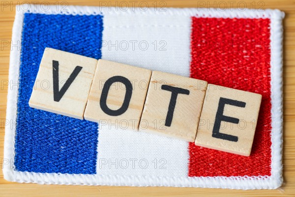 Voting in France. The flag of France and wooden blocks with the word Vote