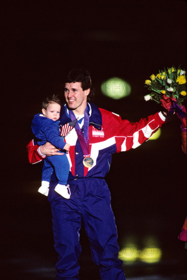 Dan Jansen (USA) with  his baby daughter after winning the gold in the 1000 meters speed skating event.