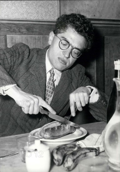 Apr. 28, 1958 - Darry Cowl As School Teacher Darry Cowl, the famous French screen Comedian, is starring in the new film ''Le Petit Prof'' (Little School Teacher) now in the making. Some of the scenes were filmed at Janson-de-Sailly, the well-known Paris High School for boys. OPS:- Darry Cowl seen having a quick lunch between two scenes.