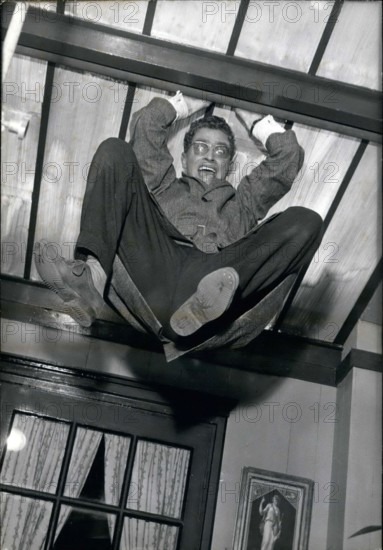 Aug. 17, 1960 - Darry Cowl is pictured in a funny scene in which he hangs from the ceiling in Jacques Poitrenaud's movie ''Paris Loves'