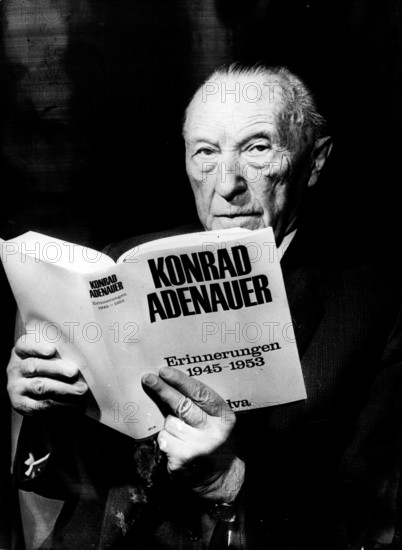 Konrad Adenauer holding an edition of his memoirs