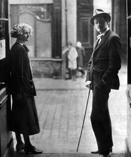 JAMES JOYCE (1882-1941) Irish author in 1920 with Silvia Beach who was the first to publish his novel Ulysses. They stand at the entrance to her Parisian bookshop Shakespeare & Co