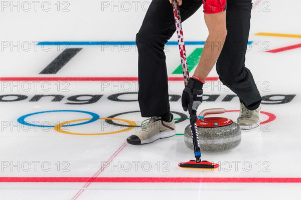 Detail of curling broom and stone at the Olympic Winter Games PyeongChang 2018