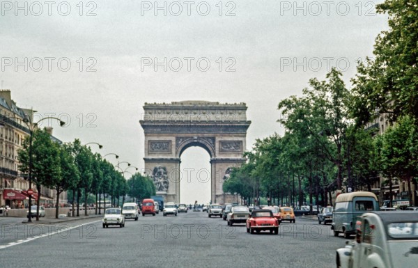Traffic at the Arc de Triomphe in Paris. Morning commuter traffic.  Archival shot scanned from transparency; 1972. Scanned images may prove a little n
