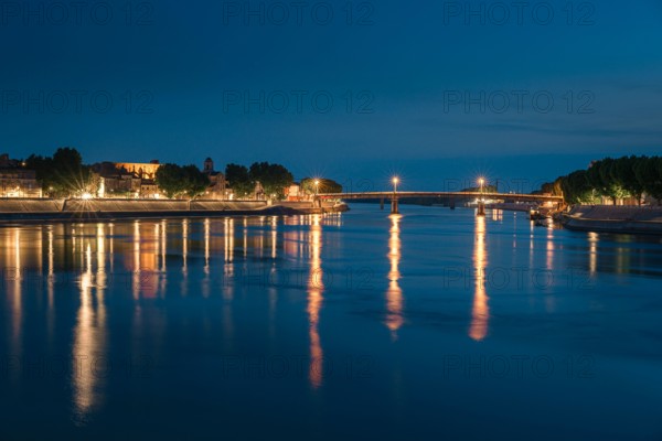 Night panoramic view of the French city, Arles on the River Rhône at night.