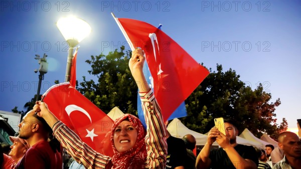 Turkey. 15th July, 2022. People with Turkish flags , some of them with President Erdogan and Ottoman flag attended July 15 Democracy and National Unity Day's events to mark July 15 defeated coup's anniversary at Konak Square. 249 people were martyred and nearly 2,200 people injured in the defeated 15th of July 2016 coup attempt. Credit: Idil Toffolo/Alamy Live News