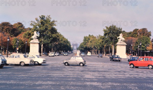 Cars on the Champs Elysees in Paris France, the Arch de Triomphe in the background ca. 1976