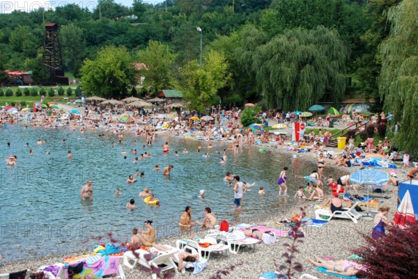Tuzla, Bosnia and Herzegovina: Pannonian Lakes Complex. Overcrowded open swimming pools during peak of tourist season. Many swimmers in water.
