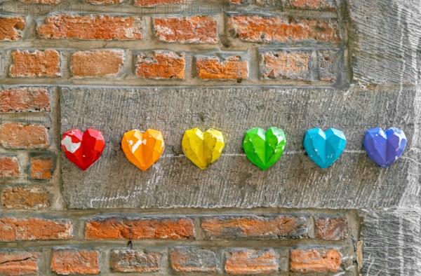 Rainbow flag decoration on brick wall, pride month concept