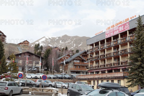 La Toussuire ski resort in Maurienne valley, French Alps, winter season with limited snow and apartment buildings, Savoie, France