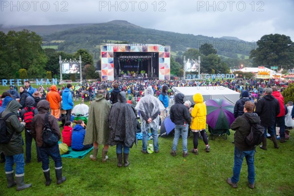 A massive storm comes in over the mountains as BRITISH SEA POWER play on the Mountain Stage with their usual flair for unusual stage invasions. Day One of the Green Man music festival in Glanusk Park, Brecon Beacons Mountains, Wales, UK on 18 August 2017. Photo: Rob Watkins.   INFO: British Sea Power, an English indie rock band, captivate audiences with their eclectic sound and energetic live performances. Albums like "The Decline of British Sea Power" and "Do You Like Rock Music?" showcase their melodic hooks and imaginative lyrics. On 9 August 2021 the band changed their name to SEA POWER.
