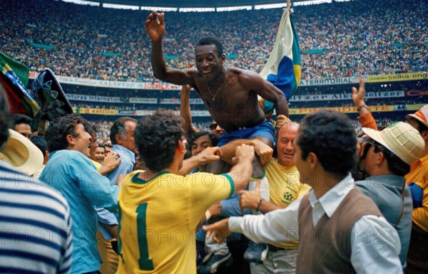 Pelé is carried on the shoulders of teammates after leading the Brazil national football team to victory over Italy national football team in the 1970 FIFA World Cup Final. Brazil won 4–1 to claim their third World Cup title