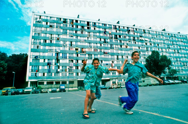 Montfermeil, France, Parisian 1960s Suburbs, low income Public Housing Projects, HLM Façade Young Immigrants Boys Playing in Yard, modern design 1960s