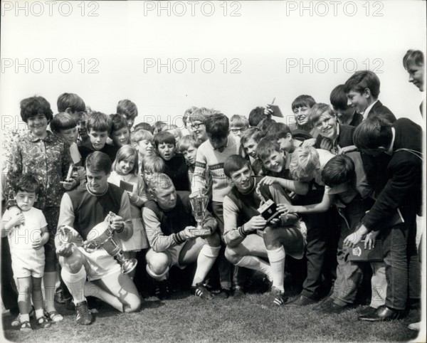 Aug. 17, 1966 - West Ham?s World Cup players show their trophies ? Taking time out from training at Chadwell Heat yesterday, West Ham?s three World Cup players show trophies to young fans. (L to R): Geoff Hurst, with his trophy as ?Player of the Match? in the World Cup Final; England captain Bobby Moore with his ?People? trophy as the World Cup?s outstanding player, and Martin Peters with Bobby Moore?s Sportswriters trophy. The new season starts on Saturday.