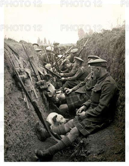 Historic image of WW1 Highland territorials and their mascot dog wait to 'go over the top' in a trench in Northern France