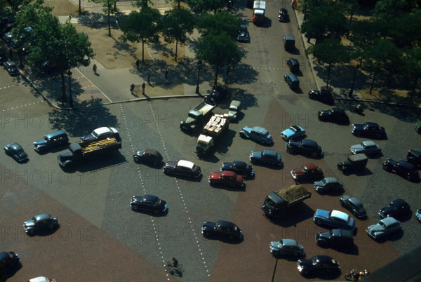 Vintage 1960's Paris France traffic as from the Arc de Triomphe looking down on the Place Charles de Gaulle
