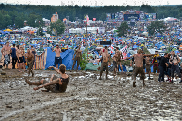 KOSTRZYN NAD ODRA, POLAND - AUGUST 4: Festival Przystanek Woodstock - fans bath in the mud in front camping  on August 4, 2012 i