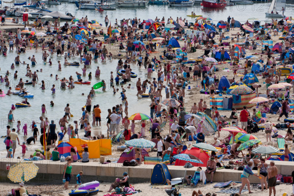 Lyme Regis, United Kingdom - July, 28 2008: Packed summer beach at Lyme Regis on the Dorset Coast