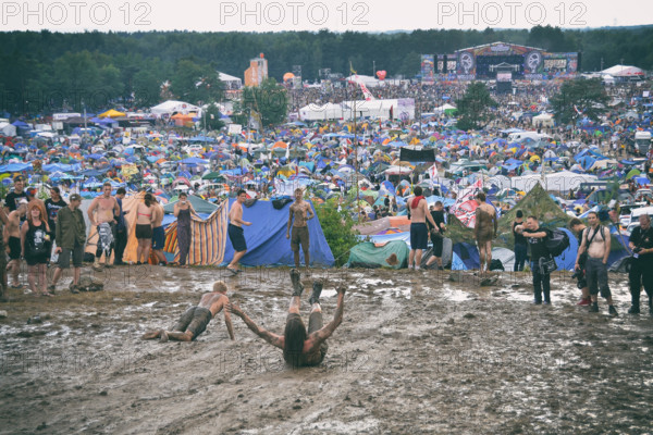 KOSTRZYN NAD ODRA, POLAND - AUGUST 4: Festival Przystanek Woodstock - fans bath in the mud in front camping  on August 4, 2012 in Kostrzyn Nad Odra, P