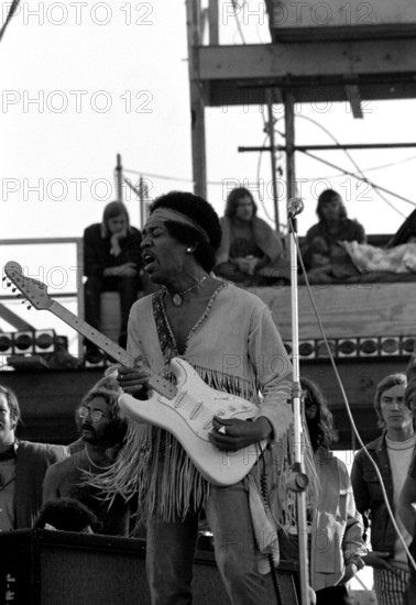 Jimi Hendrix performing his legendary 2 hour performance at Woodstock Music & Arts Festival held on Sam Yasgur's alfalfa field in Sullivan County in Bethal, New York on August 18, 1969. Hendrix insisted he close the festival and was scheduled to appear at midnight but due to delays did not take the stage until 9 am Monday morning. Most of the crowd had left for home by then and had dwindled from a whopping 500,000 to measly 80,000. ** HIGHER RATES APPLY ** CALL TO NEGOTIATE RATE ** © Peter Tarnoff / MediaPunch