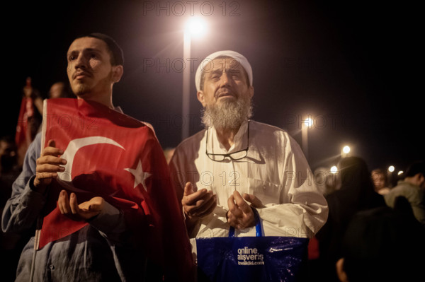 Turkish citizens seen with the Turkish flag during the national unity day. A large crowd of people gathered for the  Meeting at "July 15 Martyrs Bridgeí, previously known as Bosphorus Bridge. The celebration commemorated  the second anniversary of the attempted coup between 15 and 16 July 2016, in which early 250 people died in the coup and approximately 2,200 were wounded. Since then the government launched a crackdown on those reportedly affiliated with coup organizers, which caused the arrest of nearly 50, 000 and a massive dismissals of State employees. Following the celebration the crowd