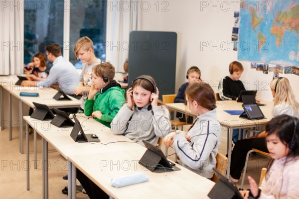 Children in classroom using digital tablet